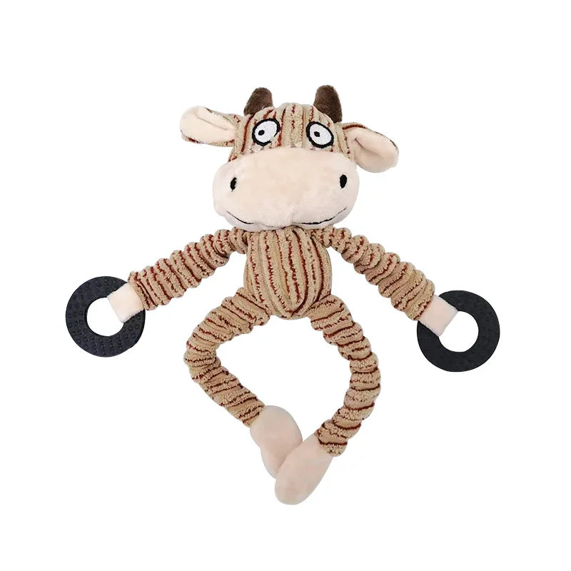 Plush toy cow with black wheels on a white background