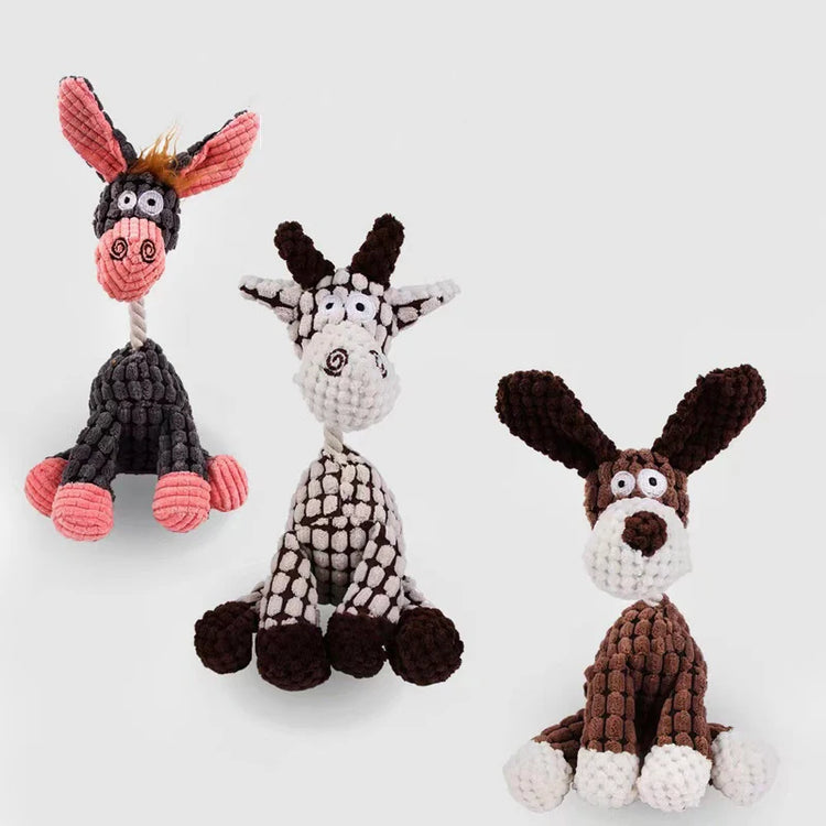 Three knitted dog toys shaped like a donkey, zebra, and rabbit on a white background